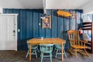 a dining room with a wooden table and chairs at 04- Kodiak Bear At Village Suites Inn in Big Bear Lake