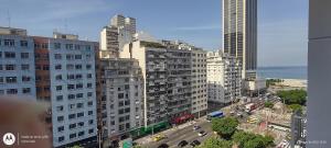 a city with tall buildings and a street with cars at Temporada Copacabana Salu 2 in Rio de Janeiro