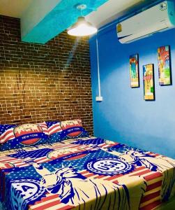 a bed in a room with blue walls at VR hostel สะพานควาย in Bang Su
