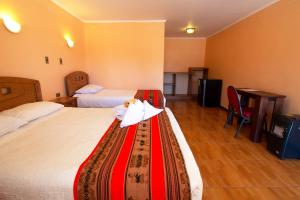 Cama o camas de una habitación en Inti & Killa Hostal