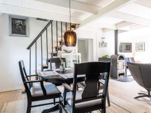 a dining room with a table and chairs at Holiday home Vejers Strand XIX in Vejers Strand