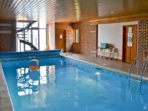 a large swimming pool with a ball in the middle at Clamp Farm Barn in Stowmarket