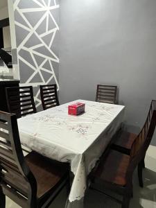 a dining room table with a red box on it at DRest Homestay Desa Aman 