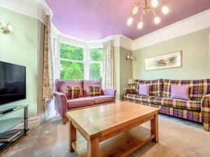 a living room with a couch and a table at Greenbank in Keswick