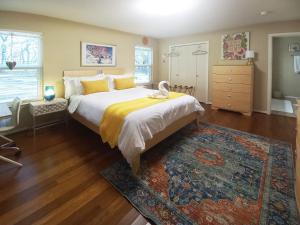 a bedroom with a large bed and a rug at Master Bedroom with King Bed-FREE-WiFi-Snack-Parkg in Relaxing Oasis in San Marcos