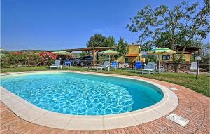 einen Pool mit Stühlen und Sonnenschirmen im Hof in der Unterkunft Lovely Home In Marsiliana With Private Swimming Pool, Can Be Inside Or Outside in Marsiliana
