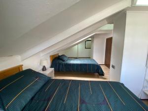 a bedroom with two beds and an attic at Departamento con vista al mar in Viña del Mar