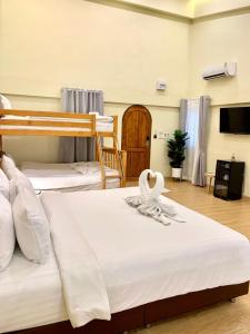 sypialnia z 2 łóżkami piętrowymi i ręcznikami w obiekcie The Nimman Hotel - SHA Plus w mieście Chiang Mai