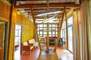 a living room with wooden walls and a staircase at LITTLE BEE HOUSE in Trại Vang