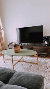 a living room with a tv and a coffee table at Kamilia Homestay KB City Centre in Kota Bharu