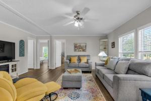 a living room with a couch and a tv at Beachin' Fun in Navarre