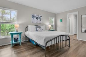 a bedroom with a bed and a blue end table at Beachin' Fun in Navarre