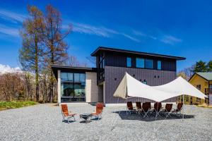 a tent is set up in front of a house at Hakuba Jolie Maison by Jade Group in Hakuba