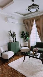 a living room with a couch and a table at Kamilia Homestay KB City Centre in Kota Bharu