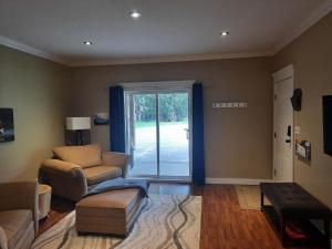 a living room with a couch and a chair at Beaver Hut Bed And Breakfast in Port Alberni +24 photos