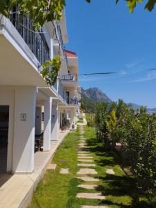 a walkway between buildings with mountains in the background at Kaş Şirinevler Apart in Kaş