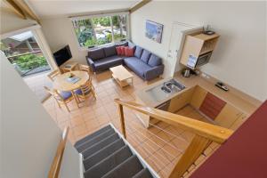 an overhead view of a living room with a couch and a table at Tathra Beach House Holiday Apartments in Tathra