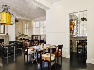 a dining room with a table and chairs at CIRCA 1936 Art Hotel in Corowa