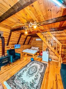 a living room with a staircase in a log cabin at Oce Bungalow in Ardeşen