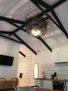 a dining room with a ceiling with a chandelier at Hopkins Homestead Farm Stay Studio in Kettering