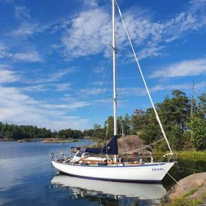 a sailboat sitting in the water on a lake at Varuna jachta in Nida