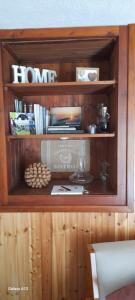 a wooden shelf with books and other items on it at Baita salzkabe in Macugnaga