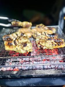 a group of food cooking on a grill at Lapwing Lake Villa in Tissamaharama