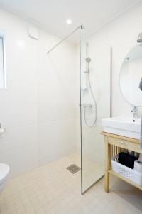 a bathroom with a glass shower and a sink at Papli Beach Apartment in Pärnu