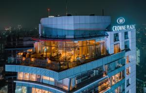 a view of a building at night with a sign on it at Crowne Plaza Dhaka Gulshan, an IHG Hotel in Dhaka