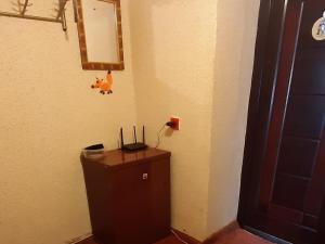a room with a dresser with a lamp on it at Эконом вариант - спальный район in Chernihiv
