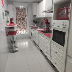 a white kitchen with a sink and a dishwasher at JT CHICLANA, ,Parking, Aire, Wifi, TV, Terraza in Chiclana de la Frontera