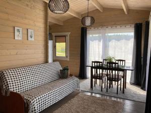 a living room with a couch and a table at Kaimo Turizmo Sodyba Šniūrai in Mindūnai