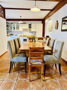 a dining room with a wooden table and chairs at Vila Friuli Karst in Komen