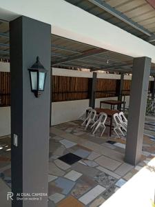 a patio with chairs and a table and a lamp at AS Ilaya Resort and Event Place powered by Cocotel in Nasugbu