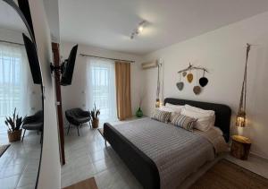 a bedroom with a bed and a television in it at Swallow's Nest Apartment in Paradeísion