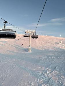 a ski lift going up a snow covered slope at Levi Ski IN Ski OUT Premium VillaWestWind B in Levi