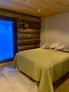 a bedroom with a bed in front of a window at Levi Ski IN Ski OUT Premium VillaWestWind B in Levi
