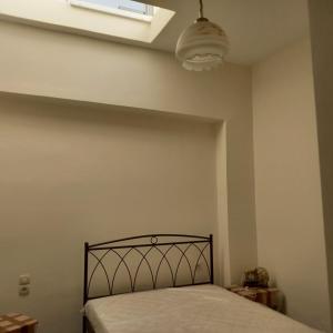 a bedroom with a bed and a skylight at Erato Elafonisi in Agios Padeleimon