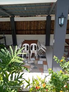 two chairs and a table on a patio at AS Ilaya Resort and Event Place powered by Cocotel in Nasugbu