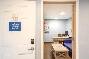 a door with a sign on it leading into a room at Wanderlust Inn in Ocean Shores +34 photos