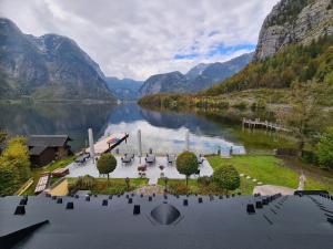 arial view of a lake with a dock and mountains at B&B Hallstatt Lake - self check in in Obertraun