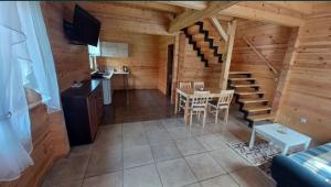 a room with a staircase in a log cabin at Słoneczne Zacisze in Smołdziński Las