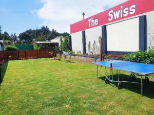 a ping pong table in the backyard of a house at The Swiss Side Iten in Iten