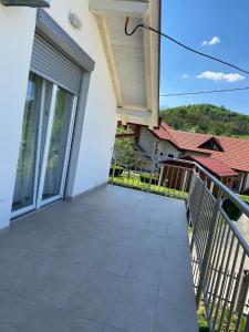 an empty balcony of a house with a window at Apartman Žepče in Žepče