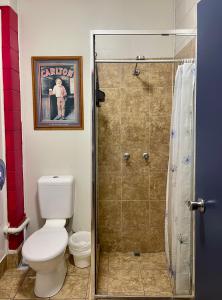 a bathroom with a shower with a toilet and a picture at Mission Beach Retreat in Mission Beach