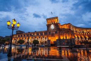 a large building with a clock tower on top of it at Studio apartment in Yerevan in Yerevan