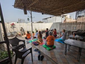 a group of children sitting on a patio at Smyle Inn - Comfort & Value near New Delhi Railway Station - since 1998 in New Delhi +54 photos