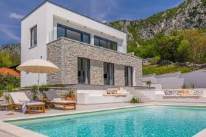a villa with a swimming pool and a house at Villa Noha in Bribir