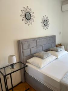 a bedroom with a bed with a table and a clock on the wall at Apartment Isabell in Split