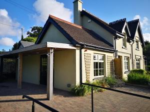 a large white house with a porch in front of it at Old Post Office Studio in Killarney